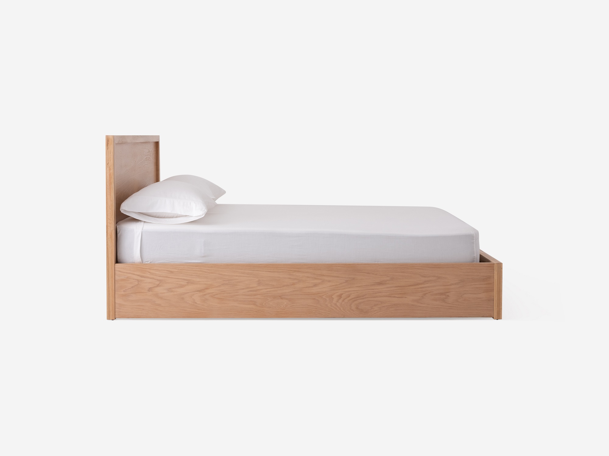 Side view of Marcel lift up storage bed in oak